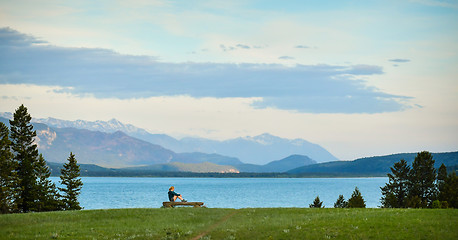 Image showing Woman enjoys the mountain and lake view