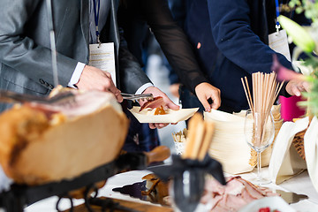 Image showing Businesspeople at banquet lunch break at business conference meeting. Assortment of food and drinks.