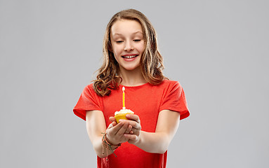 Image showing teenage girl with one candle on birthday cupcake