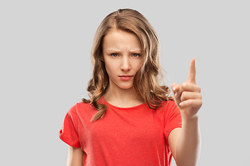 Image showing angry frowning teenage girl pointing finger up