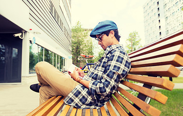 Image showing man with notebook or diary writing on city street