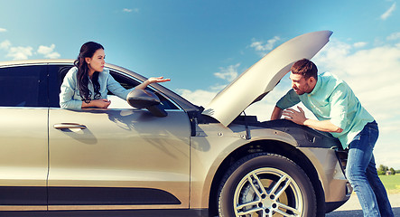 Image showing couple with open hood of broken car at countryside