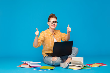 Image showing teenage student girl with laptop showing thumbs up