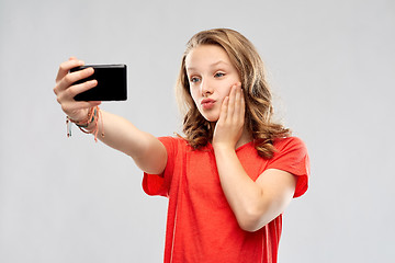 Image showing smiling teenage girl taking selfie by smartphone