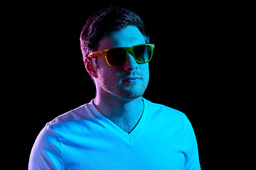 Image showing man in sunglasses over ultra violet neon lights