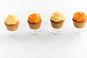 Image showing cupcakes with frosting on confectionery stands