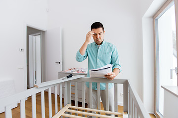 Image showing father with manual assembling baby bed at home