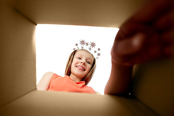 Image showing happy girl taking something out of gift box