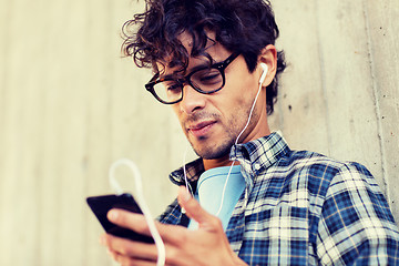 Image showing man with earphones and smartphone listening music