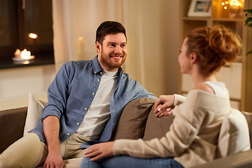 Image showing happy couple talking at home in evening