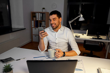 Image showing businessman with smartphone and coffee at office