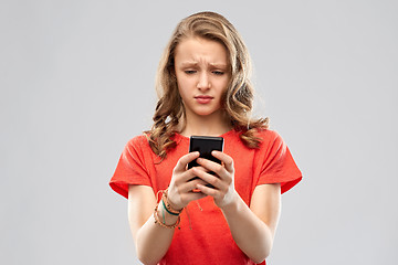 Image showing sad teenage girl using smartphone