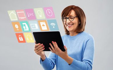 Image showing senior woman with tablet pc using smart home app