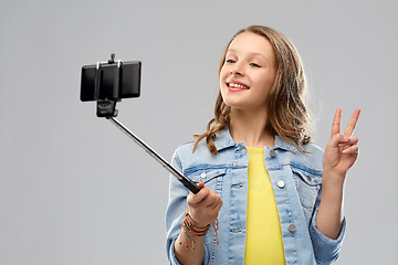 Image showing teenage girl taking selfie by smartphone