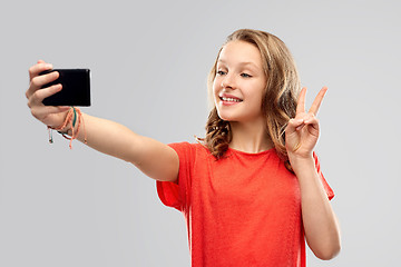 Image showing smiling teenage girl taking selfie by smartphone