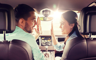 Image showing happy man and woman driving in car