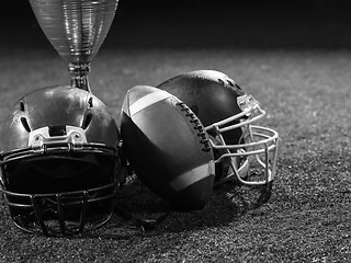 Image showing closeup of american football,helmets and trophy