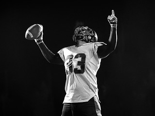 Image showing american football player celebrating after scoring a touchdown