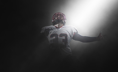 Image showing american football player celebrating after scoring a touchdown