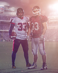 Image showing Two American football players standing  on the field