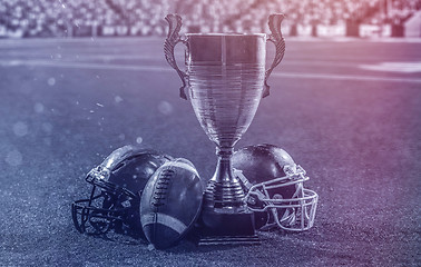 Image showing closeup of american football,helmets and trophy