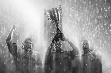 Image showing american football team with trophy celebrating victory in the cu