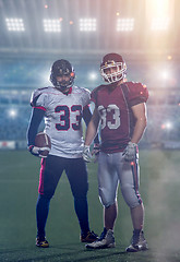 Image showing Two American football players standing  on the field