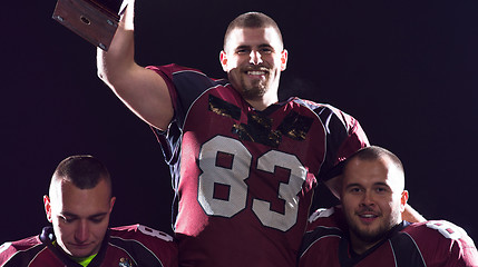 Image showing american football team with trophy celebrating victory