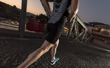 Image showing man jogging across the bridge in the city