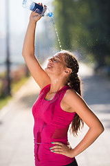 Image showing woman pouring water from bottle on her head