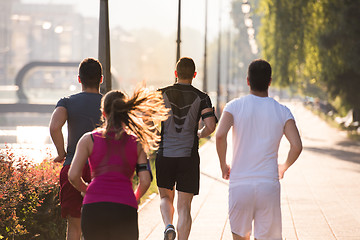 Image showing group of young people jogging in the city