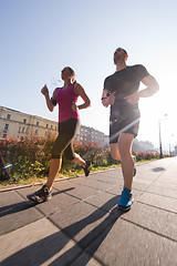 Image showing young couple jogging  in the city