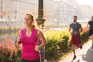 Image showing group of young people jogging in the city