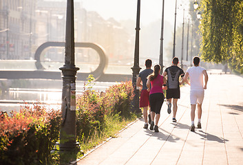 Image showing group of young people jogging in the city