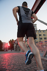 Image showing man jogging across the bridge at sunny morning