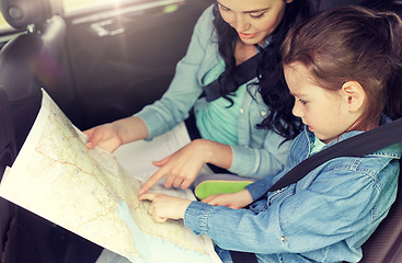 Image showing happy family with travel map driving in car