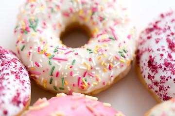 Image showing close up of glazed donuts on white table