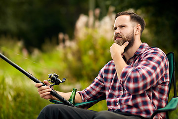 Image showing bearded fisherman with fishing rod