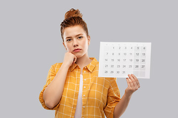 Image showing sad red haired teenage girl with calendar sheet