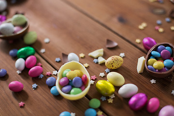 Image showing chocolate eggs and candy drops on wooden table