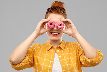 Image showing funny teenage girl with donuts instead of eyes