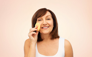 Image showing woman cleaning face with exfoliating sponge