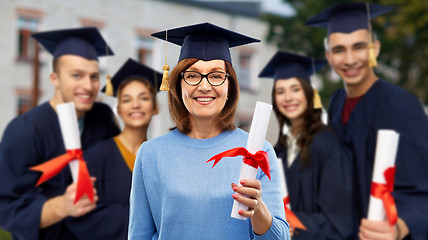 Image showing happy senior graduate student woman with diploma