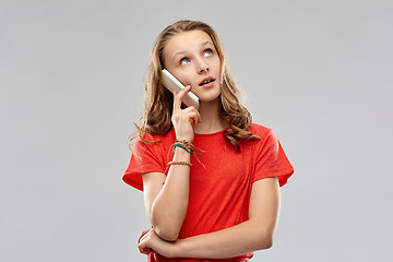 Image showing bored teenage girl calling on smartphone