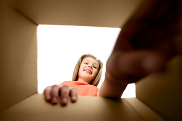 Image showing happy girl taking something out of open gift box