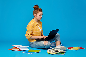 Image showing redhead teenage student girl with laptop and books