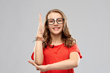 Image showing smiling student girl in glasses ready to answer