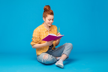 Image showing happy teenage student girl with diary or notebook