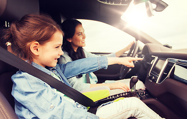 Image showing happy woman with little child driving in car