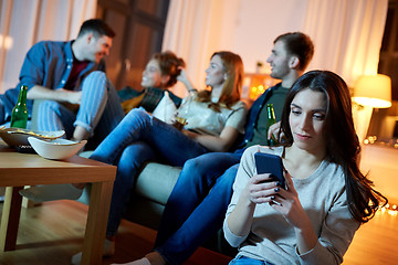 Image showing young woman with smartphone at home party